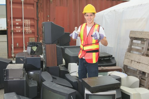 Technicians disassembling a sofa for removal